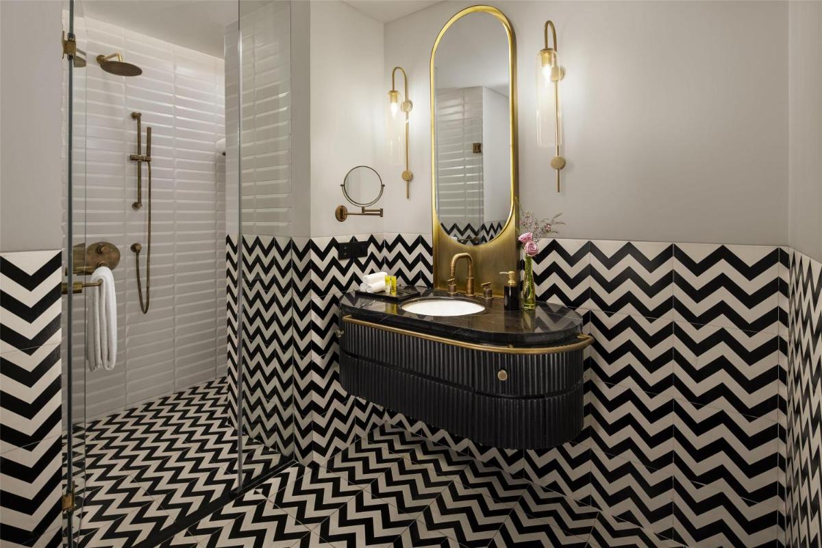 a bathroom with a black and white checkered floor at Hyatt Centric Sector17 Chandigarh in Chandīgarh