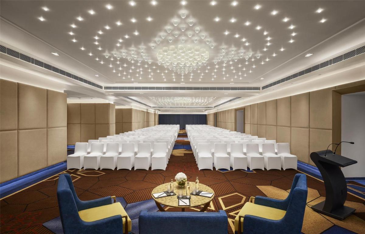a conference room with a long table and white chairs at Hyatt Centric Sector17 Chandigarh in Chandīgarh