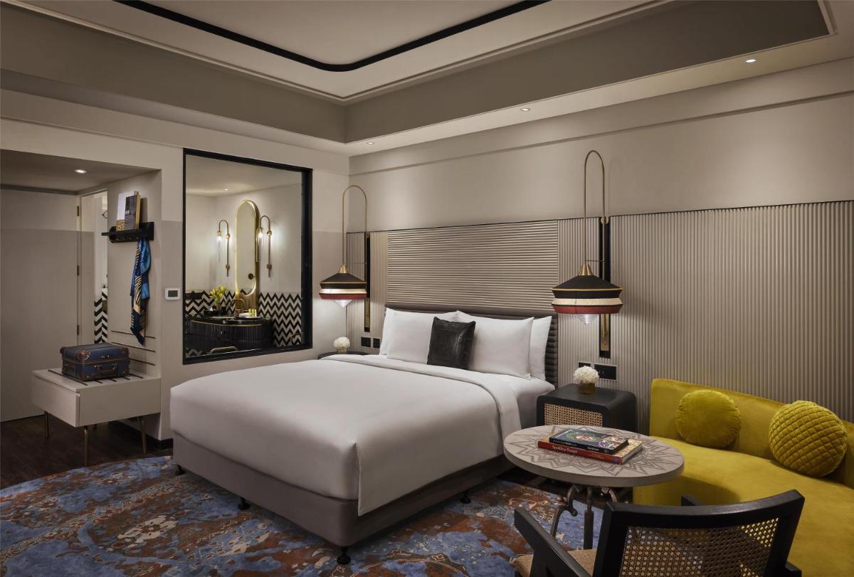 a bedroom with a large white bed and a couch at Hyatt Centric Sector17 Chandigarh in Chandīgarh