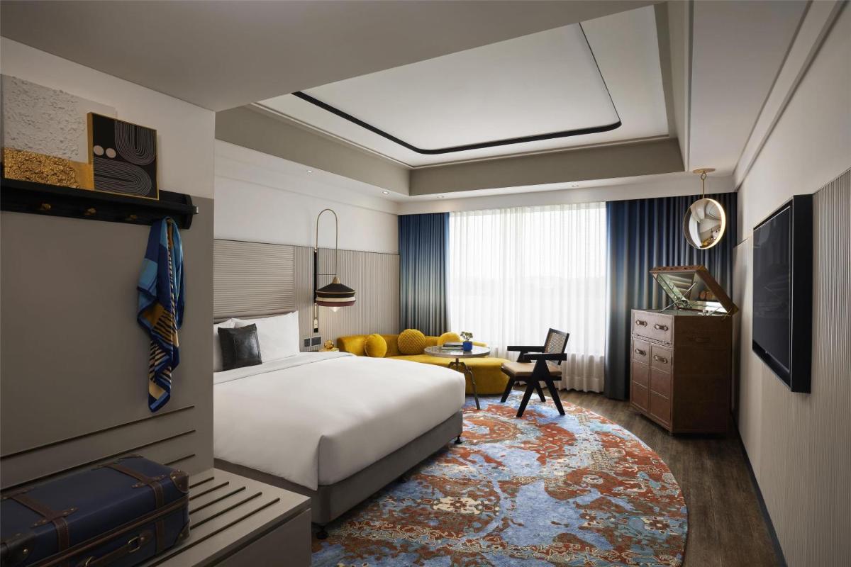 a hotel room with a bed and a desk at Hyatt Centric Sector17 Chandigarh in Chandīgarh