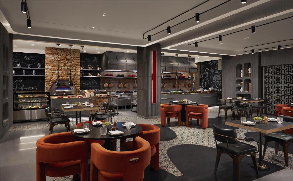 a restaurant with tables and chairs and a bar at Hyatt Centric Sector17 Chandigarh in Chandīgarh