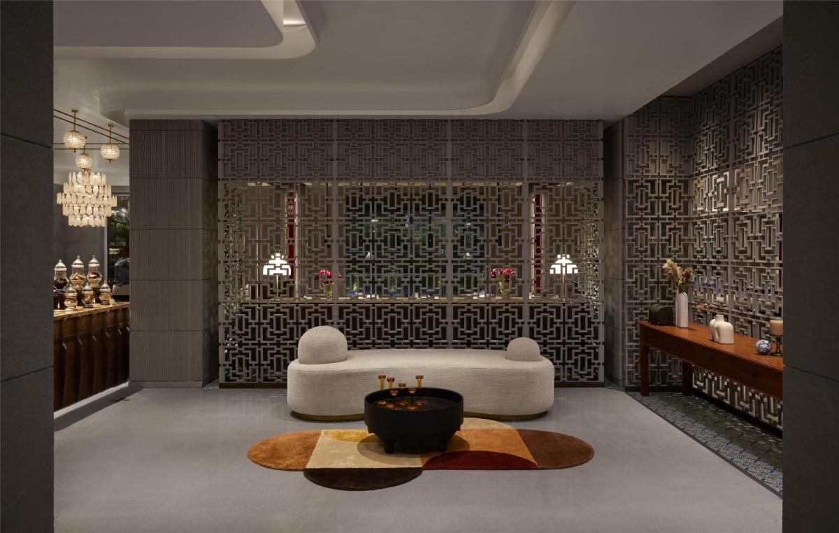 a living room with a white couch and a table at Hyatt Centric Sector17 Chandigarh in Chandīgarh