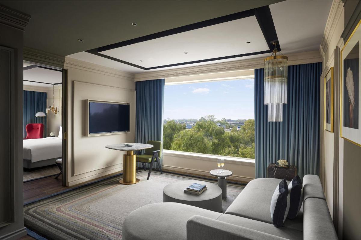 a hotel room with a couch and a large window at Hyatt Centric Sector17 Chandigarh in Chandīgarh