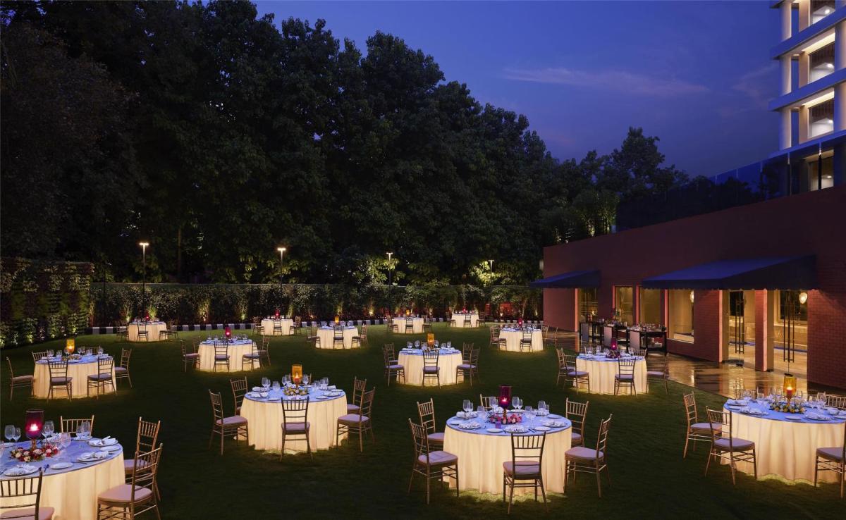 a group of tables with white table cloths at Hyatt Centric Sector17 Chandigarh in Chandīgarh