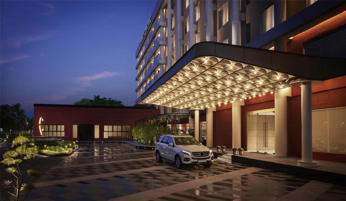 a car parked in front of a building with lights at Hyatt Centric Sector17 Chandigarh in Chandīgarh