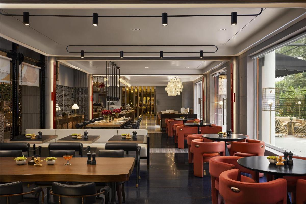a restaurant with tables and chairs at Hyatt Centric Sector17 Chandigarh in Chandīgarh