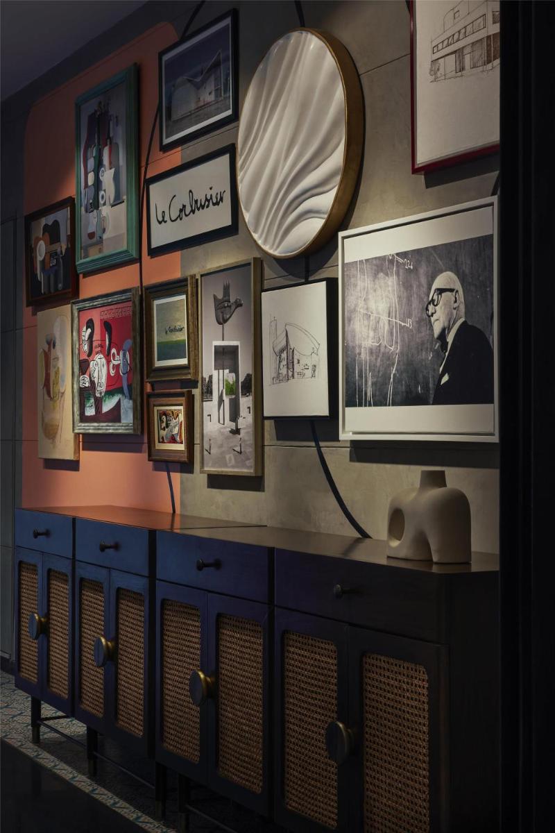 a room with a tv and pictures on the wall at Hyatt Centric Sector17 Chandigarh in Chandīgarh