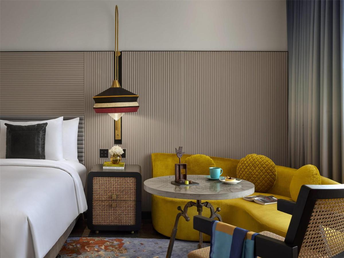 a bedroom with a bed and a couch and a table at Hyatt Centric Sector17 Chandigarh in Chandīgarh