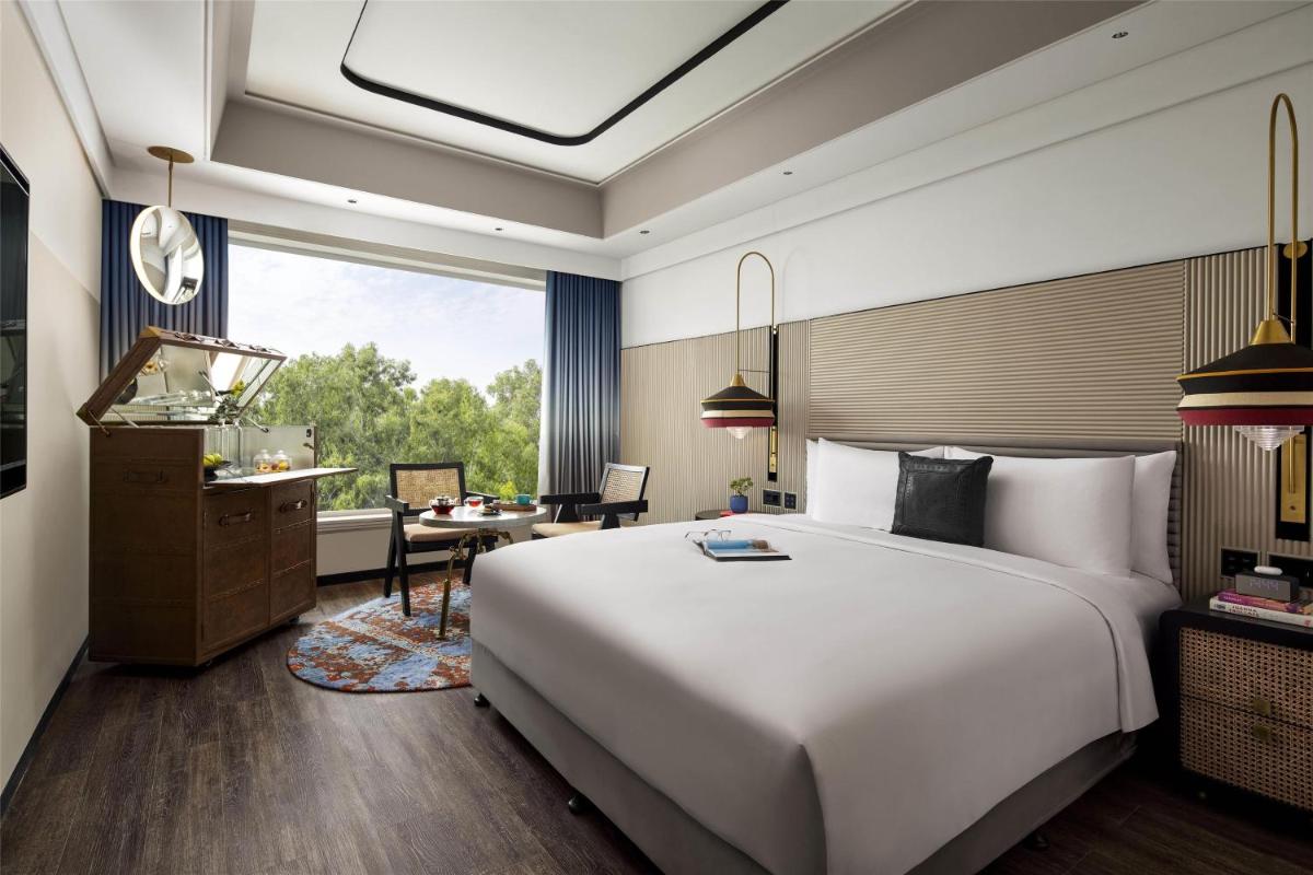 a bedroom with a large white bed and a desk at Hyatt Centric Sector17 Chandigarh in Chandīgarh