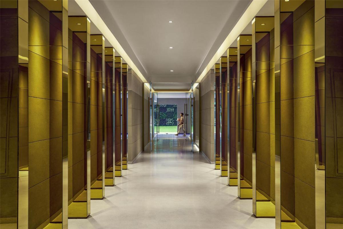 a hallway in a building with yellow columns at Hyatt Centric Sector17 Chandigarh in Chandīgarh