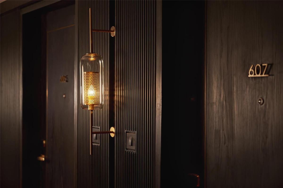 a light hanging from the side of a door at Hyatt Centric Sector17 Chandigarh in Chandīgarh
