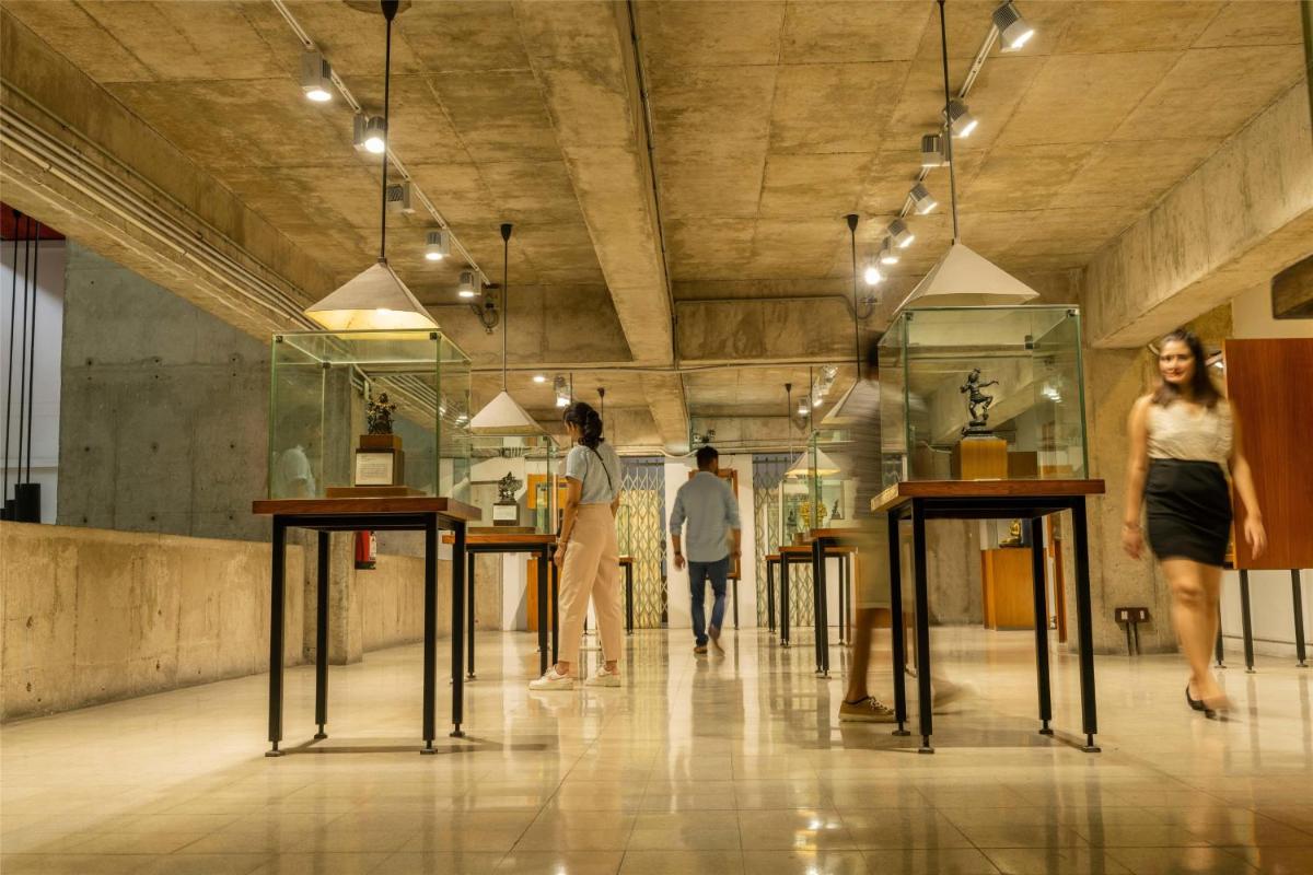 a group of people walking in a room with tables at Hyatt Centric Sector17 Chandigarh in Chandīgarh
