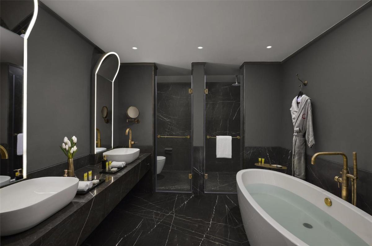 a bathroom with two sinks and a tub and a shower at Hyatt Centric Sector17 Chandigarh in Chandīgarh