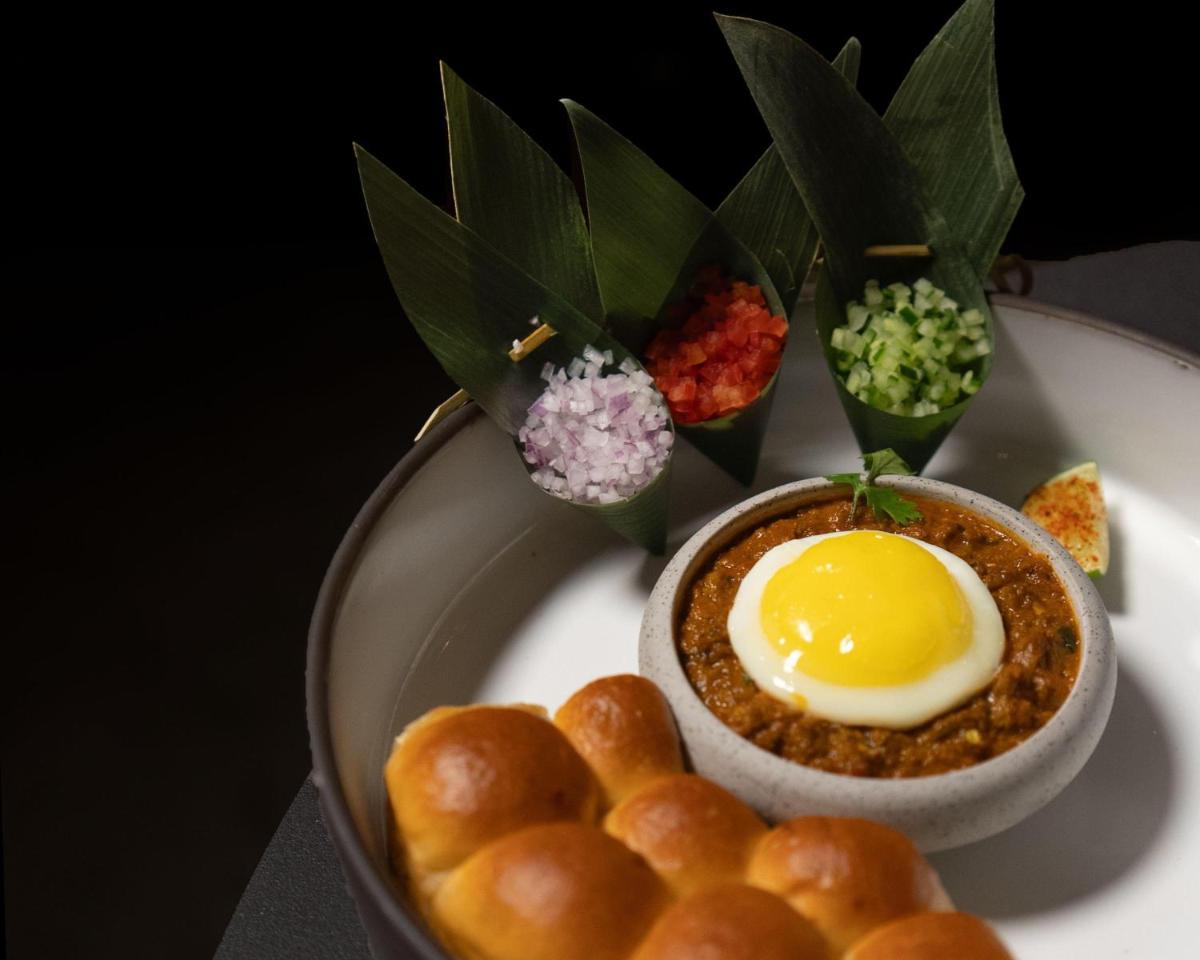a plate of food with an egg and some bread at Hyatt Centric Sector17 Chandigarh in Chandīgarh