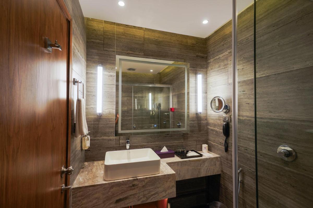 a bathroom with a sink and a mirror at Southern Star,Mysore in Mysore
