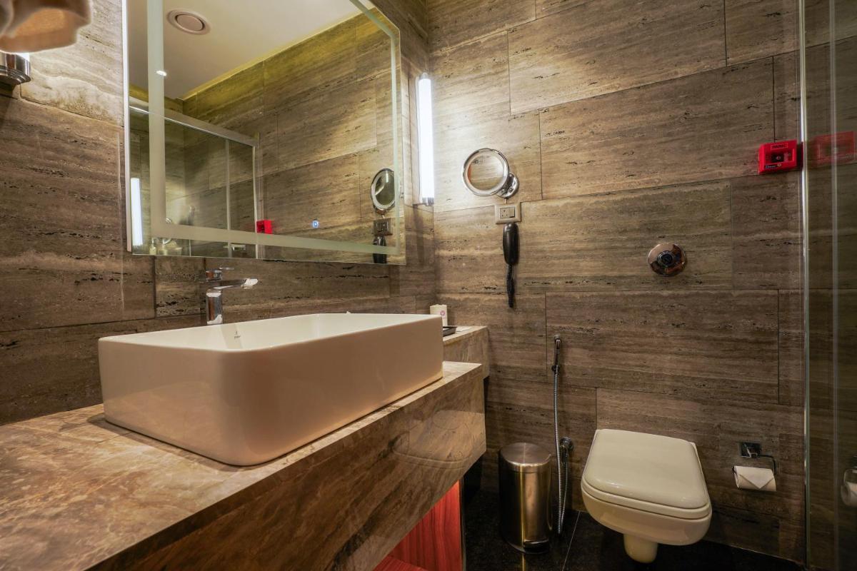 a bathroom with a sink and a toilet at Southern Star,Mysore in Mysore