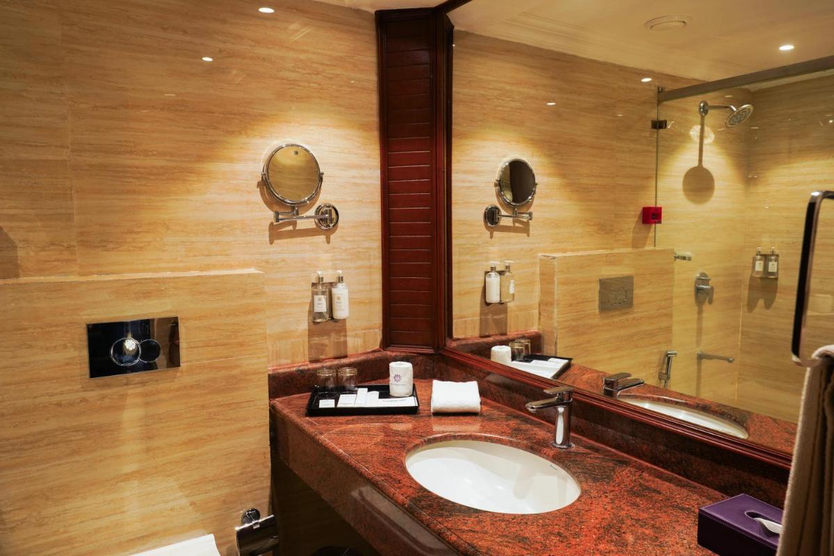 a bathroom with a sink and a mirror at Southern Star,Mysore in Mysore
