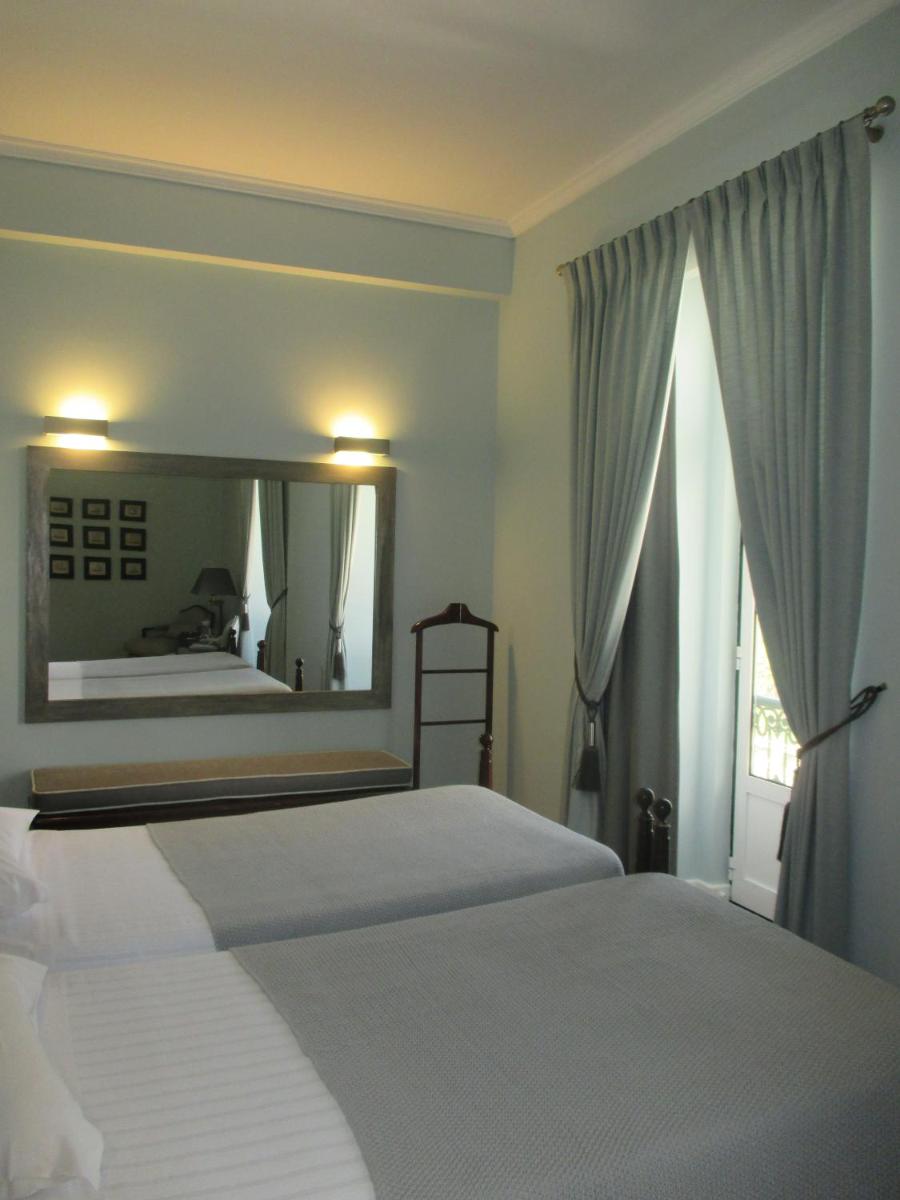 Uma cama ou camas num quarto em Grande Hotel das Caldas da Felgueira