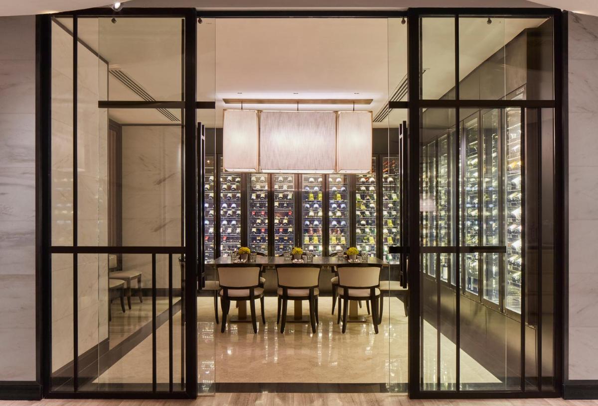 a dining room with a table and a wine cellar at The Taj Mahal Tower, Mumbai in Mumbai a dining room with a table and a wine cellar at The Taj Mahal Tower, Mumbai in Mumbai