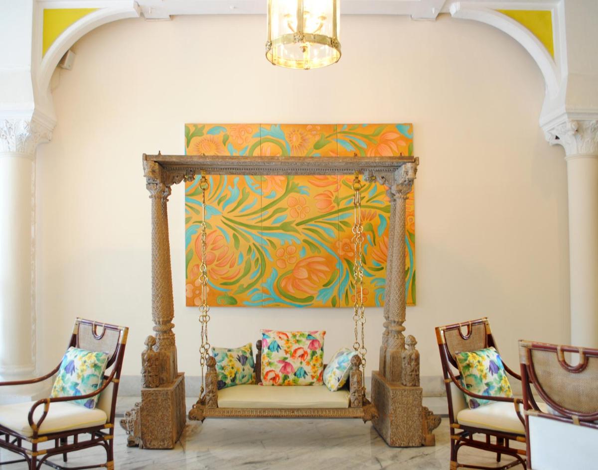 a couch in a room with two chairs and a painting at The Taj Mahal Tower, Mumbai in Mumbai a couch in a room with two chairs and a painting at The Taj Mahal Tower, Mumbai in Mumbai