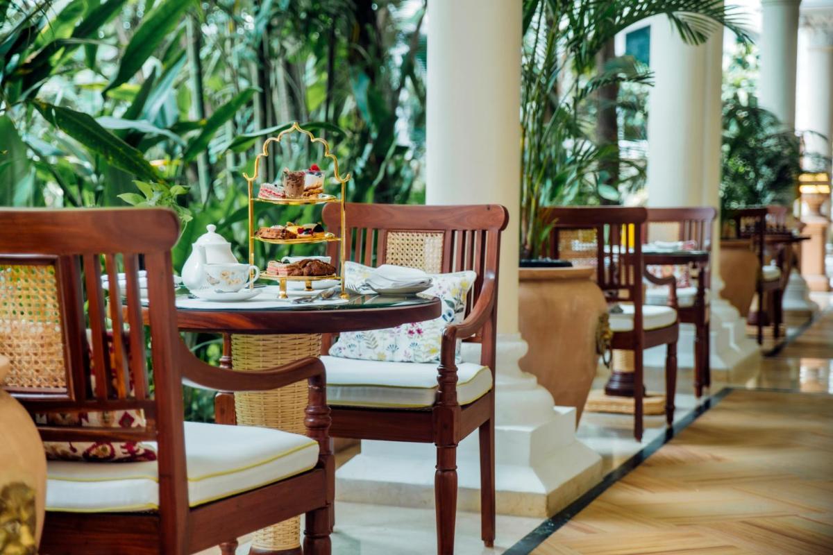 a table with a plate of food on top at The Taj Mahal Tower, Mumbai in Mumbai a table with a plate of food on top at The Taj Mahal Tower, Mumbai in Mumbai