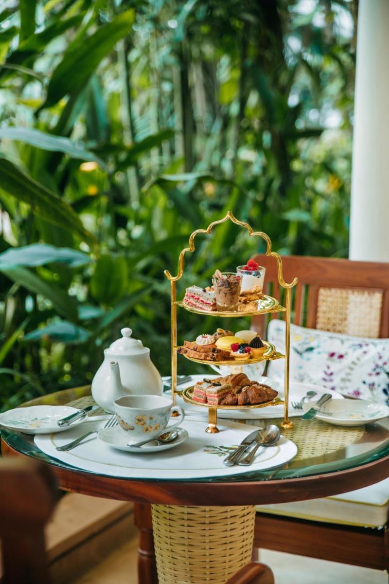 a table with three plates of food and tea cups at The Taj Mahal Tower, Mumbai in Mumbai a table with three plates of food and tea cups at The Taj Mahal Tower, Mumbai in Mumbai