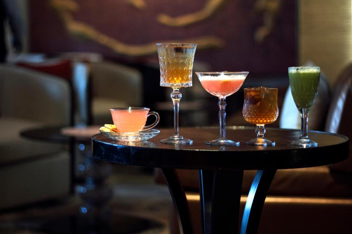 a table with four different cocktails on it at The Taj Mahal Tower, Mumbai in Mumbai a table with four different cocktails on it at The Taj Mahal Tower, Mumbai in Mumbai