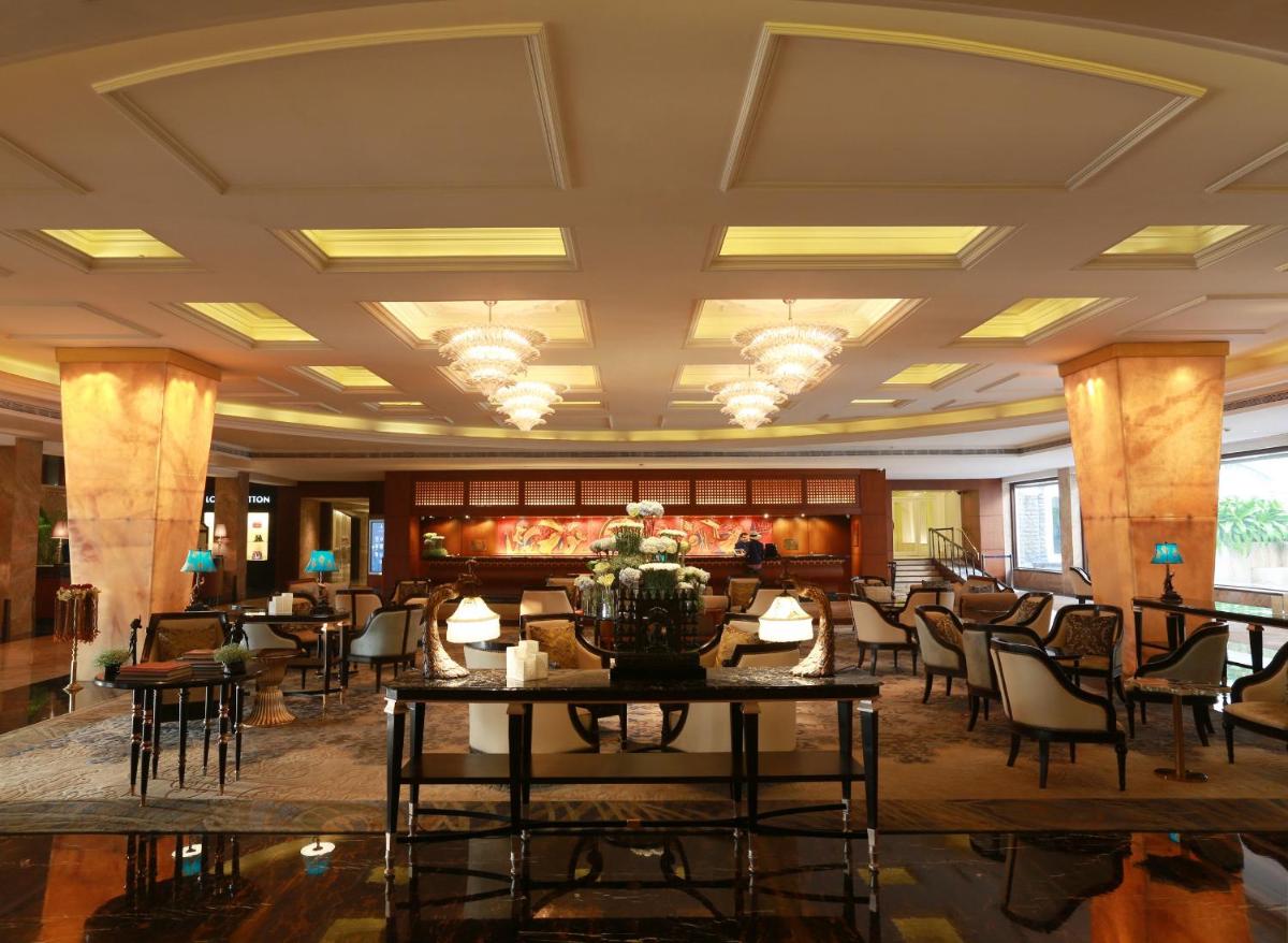 a lobby with chairs and tables in a building at The Taj Mahal Tower, Mumbai in Mumbai a lobby with chairs and tables in a building at The Taj Mahal Tower, Mumbai in Mumbai