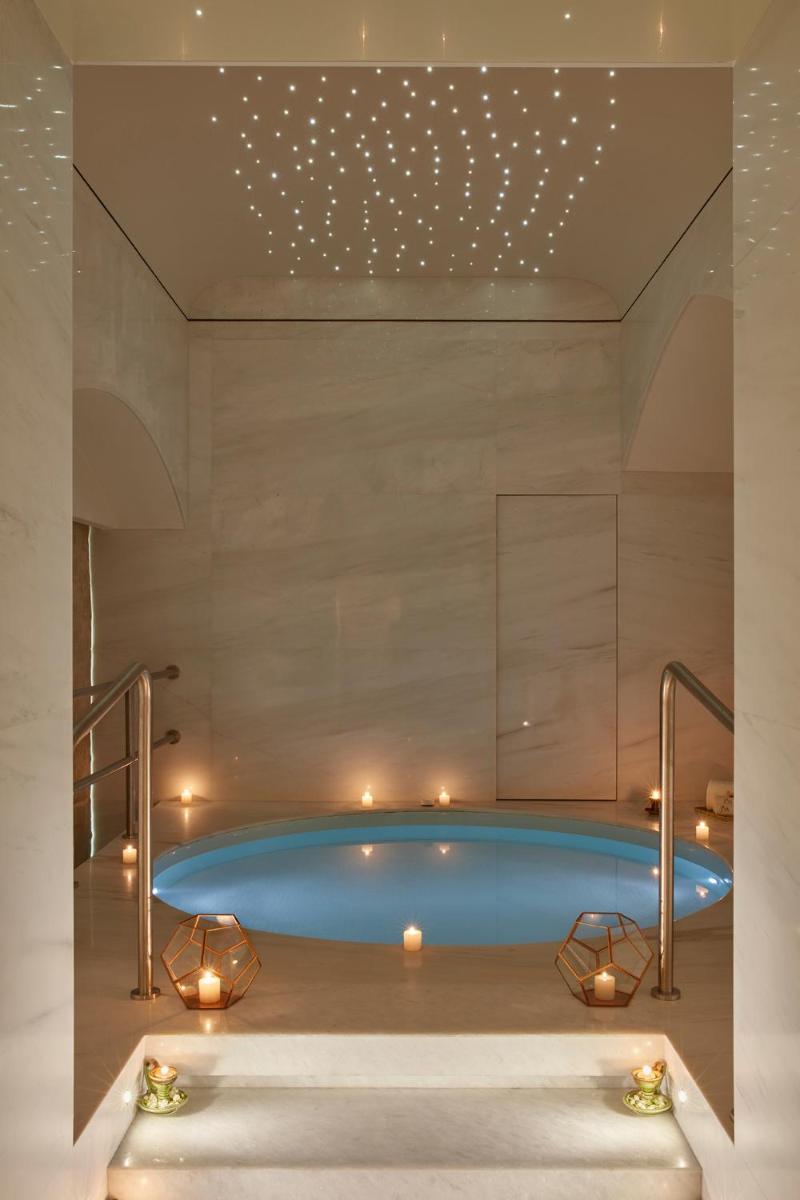 a swimming pool in a room with lights at The Taj Mahal Tower, Mumbai in Mumbai a swimming pool in a room with lights at The Taj Mahal Tower, Mumbai in Mumbai