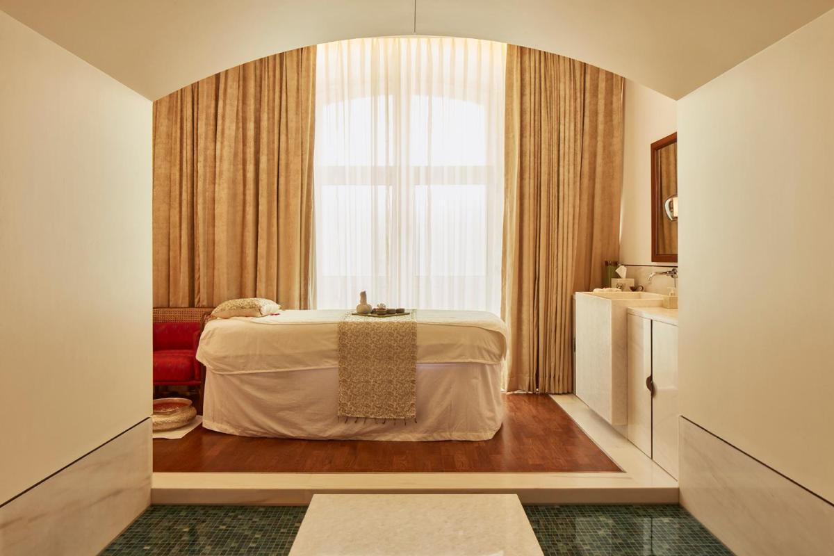 a hotel room with a bed and a window at The Taj Mahal Tower, Mumbai in Mumbai a hotel room with a bed and a window at The Taj Mahal Tower, Mumbai in Mumbai