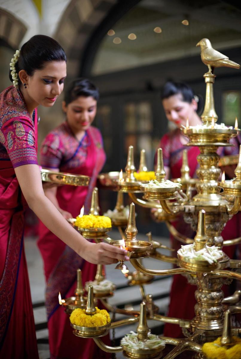 a group of people standing in front of a tray of food at The Taj Mahal Tower, Mumbai in Mumbai a group of people standing in front of a tray of food at The Taj Mahal Tower, Mumbai in Mumbai