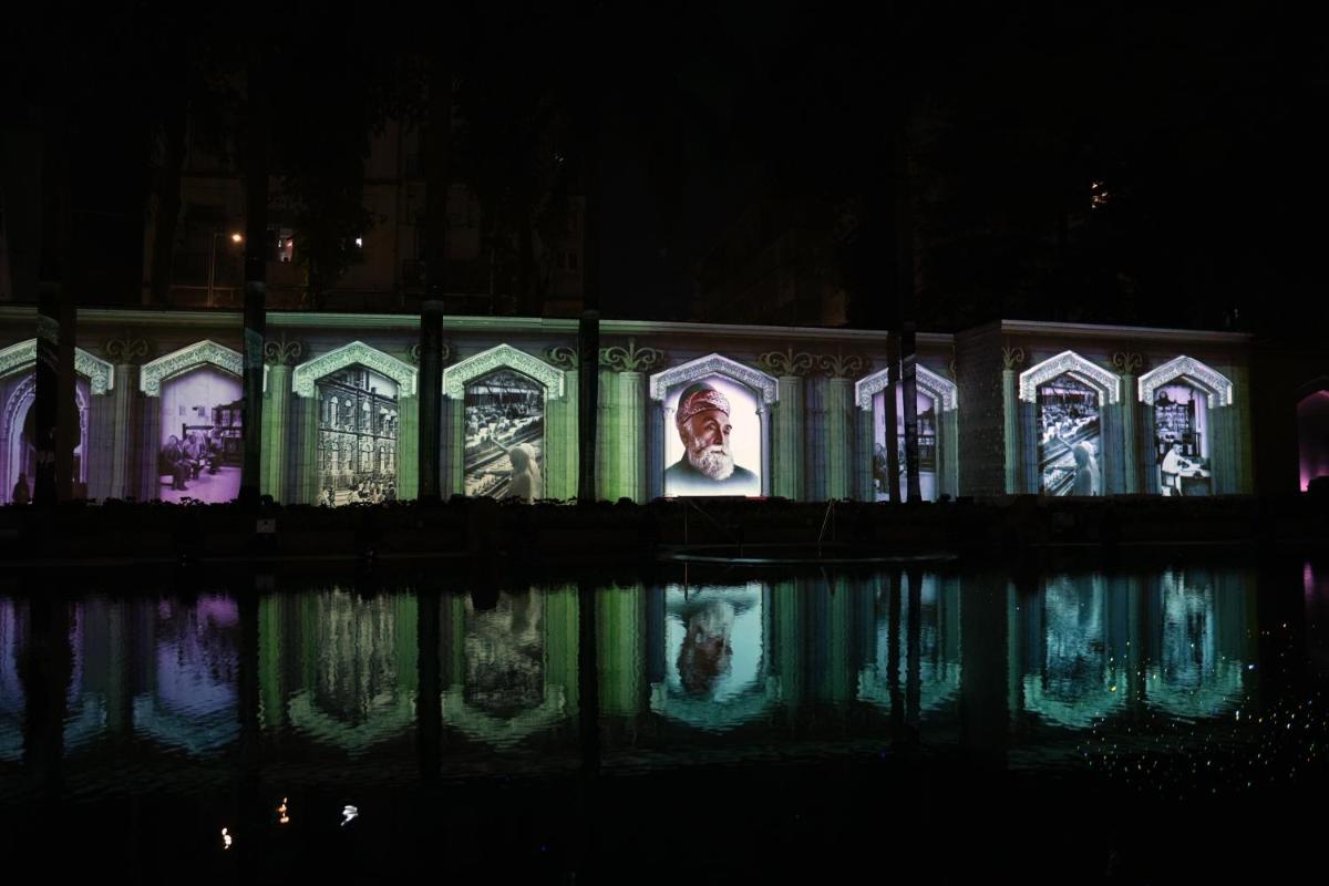 a building with a picture of a man on it at night at The Taj Mahal Tower, Mumbai in Mumbai a building with a picture of a man on it at night at The Taj Mahal Tower, Mumbai in Mumbai