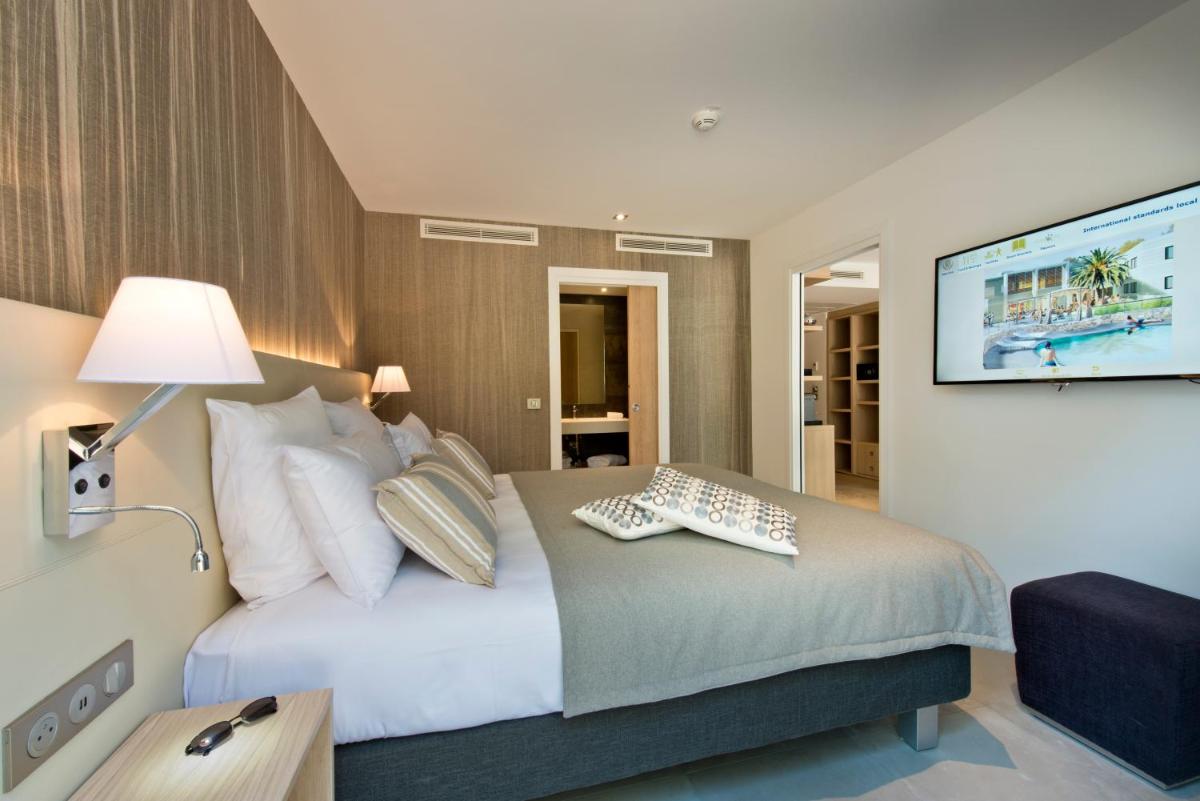 Un ou plusieurs lits dans un hébergement de l'établissement Golden Tulip Sophia Antipolis - Hotel & Spa