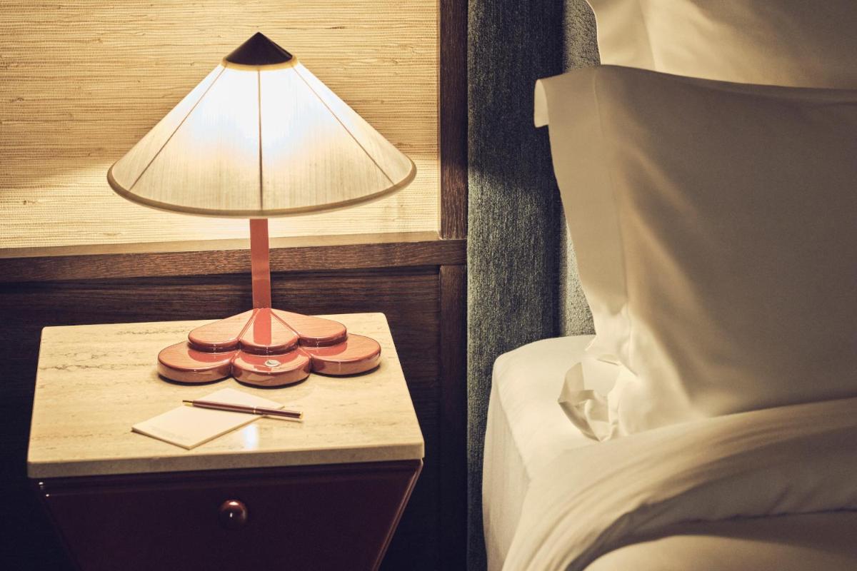 Un ou plusieurs lits dans un hébergement de l'établissement Hotel Hana