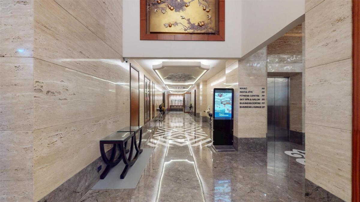 a hallway in a building with a painting on the wall at Radisson Blu Hotel, Nagpur in Nagpur