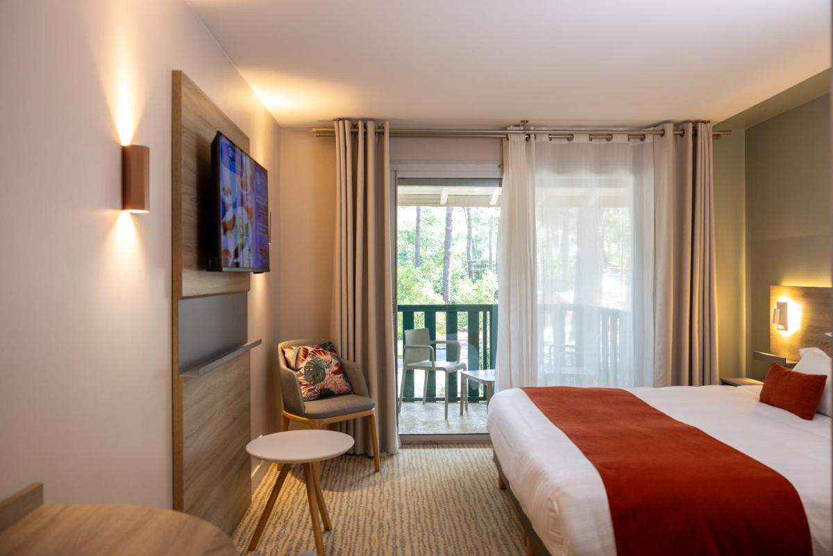 Un ou plusieurs lits dans un hébergement de l'établissement Hôtel & Spa Vitalparc, The Originals Collection