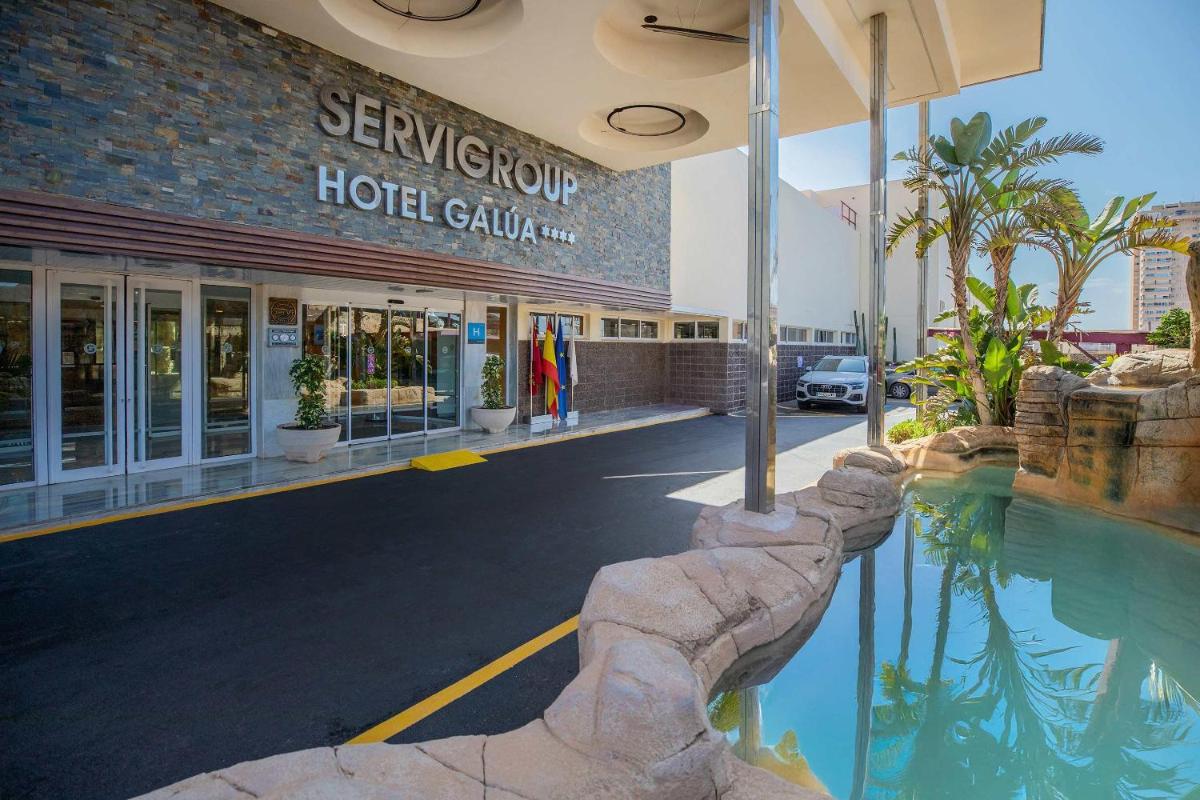 un hotel con piscina frente a un edificio en Hotel Servigroup Galua, en La Manga del Mar Menor