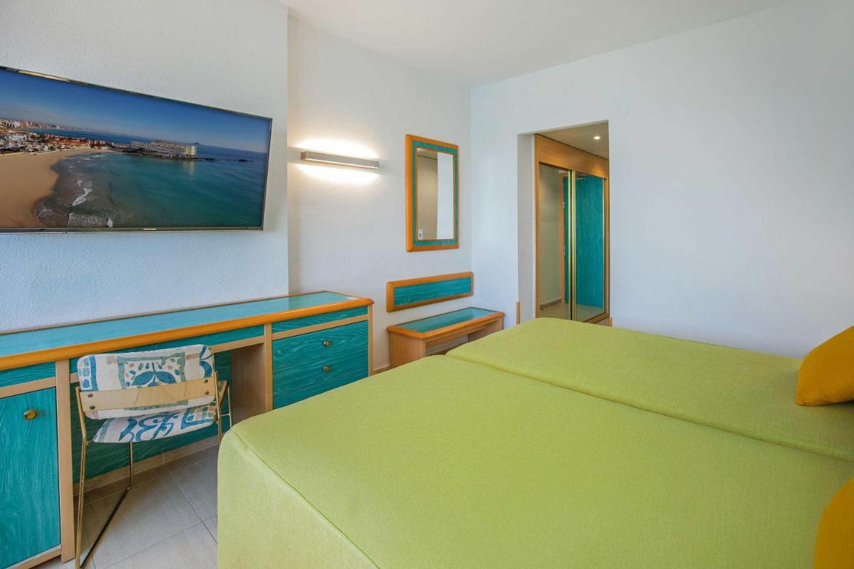 Cama o camas de una habitación en Hotel Servigroup Galua