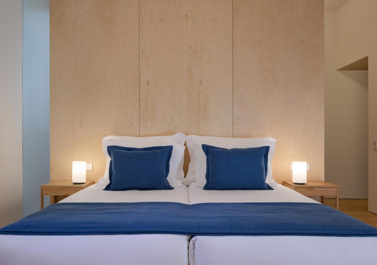Uma cama ou camas num quarto em Montebelo Mosteiro de Alcobaça Historic Hotel