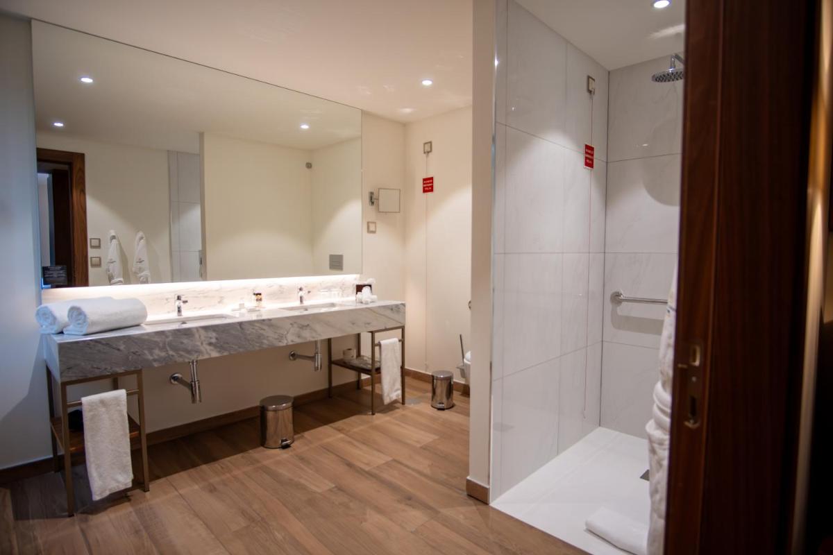 Uma casa de banho em Boeira Garden Hotel Porto Gaia, Curio Collection by Hilton