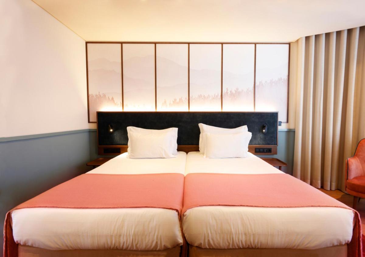 Uma cama ou camas num quarto em Montebelo Viseu Congress Hotel & Spa