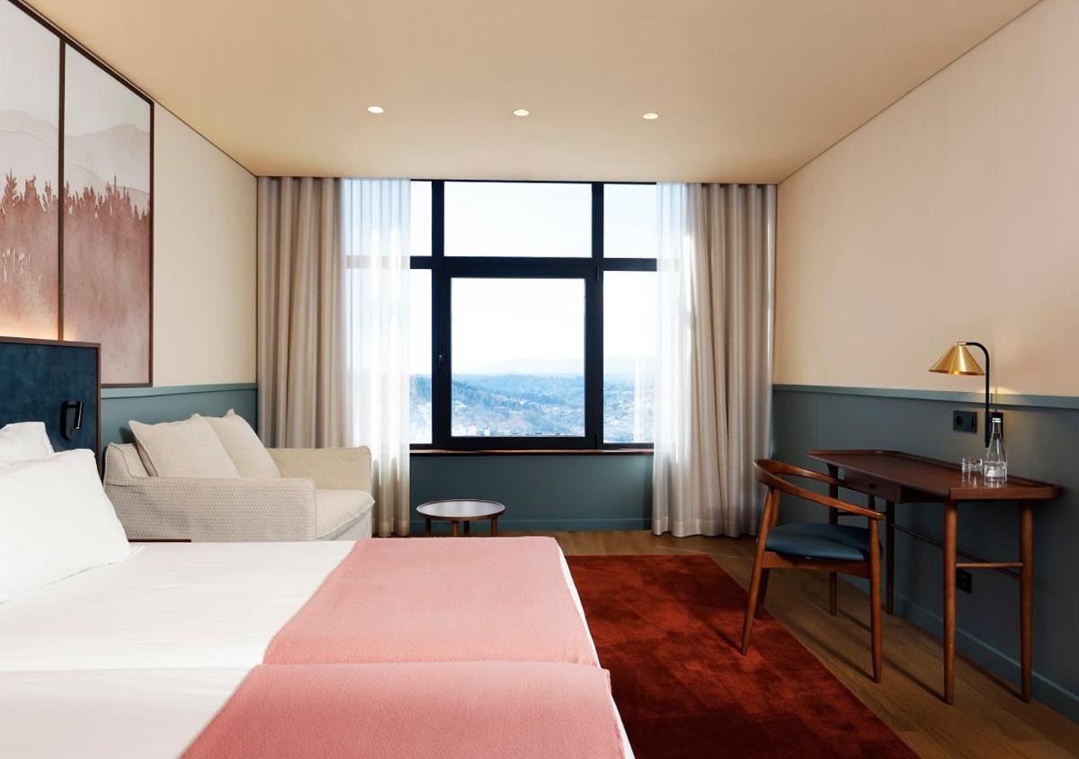 Uma cama ou camas num quarto em Montebelo Viseu Congress Hotel & Spa