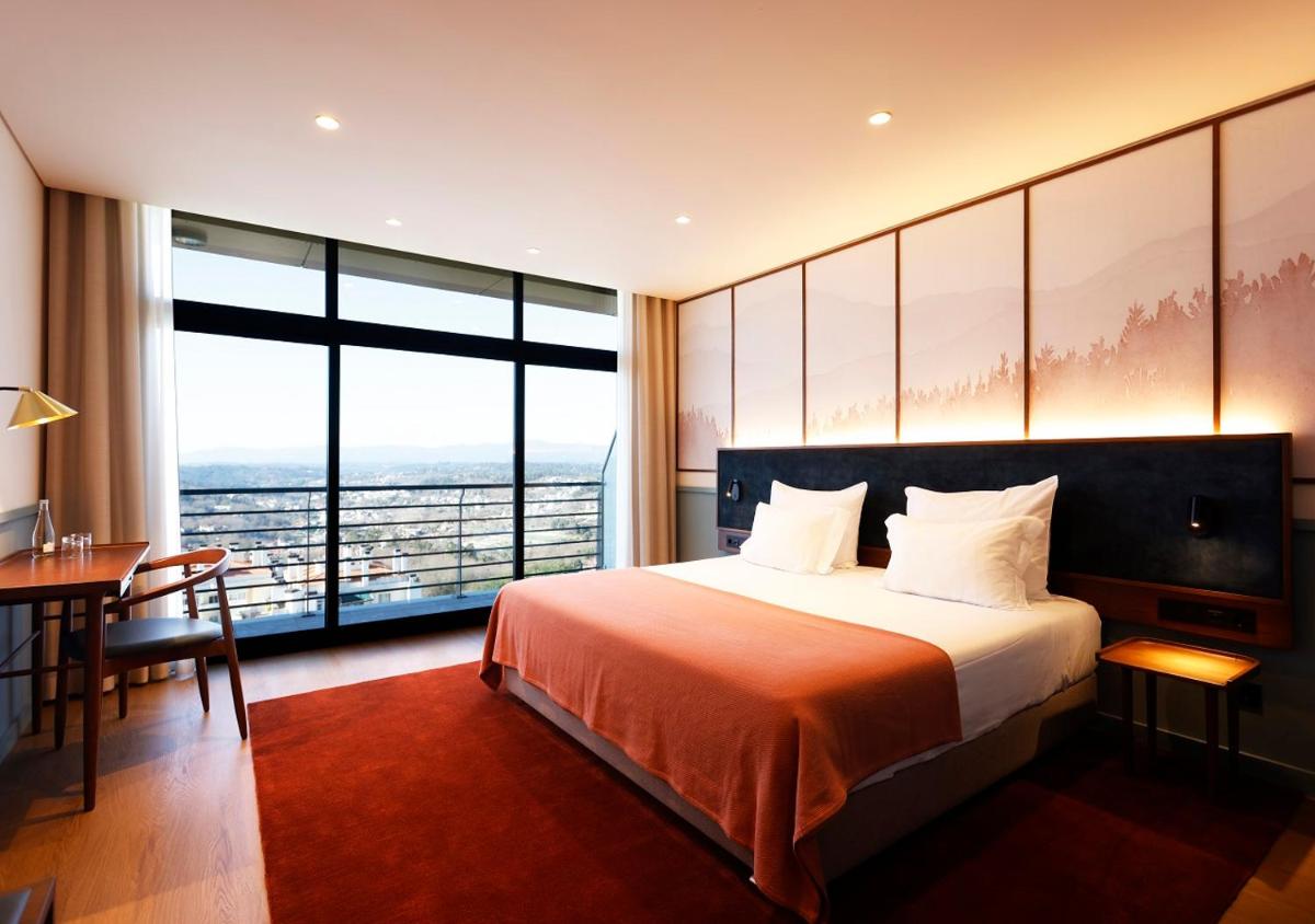 Uma cama ou camas num quarto em Montebelo Viseu Congress Hotel & Spa