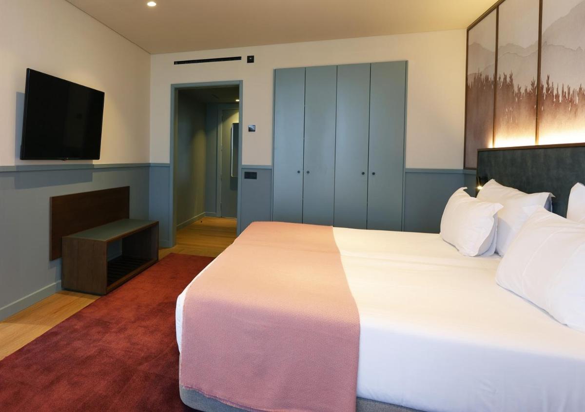 Uma cama ou camas num quarto em Montebelo Viseu Congress Hotel & Spa
