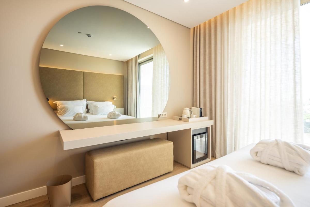 Uma cama ou camas num quarto em Castelo Suites Hotel