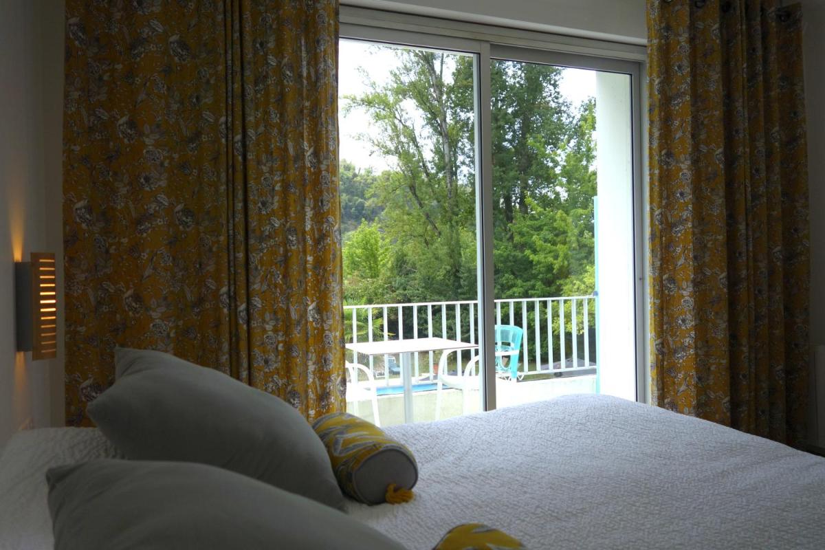 Un ou plusieurs lits dans un hébergement de l'établissement Hôtel La Ségalière Spa Bar