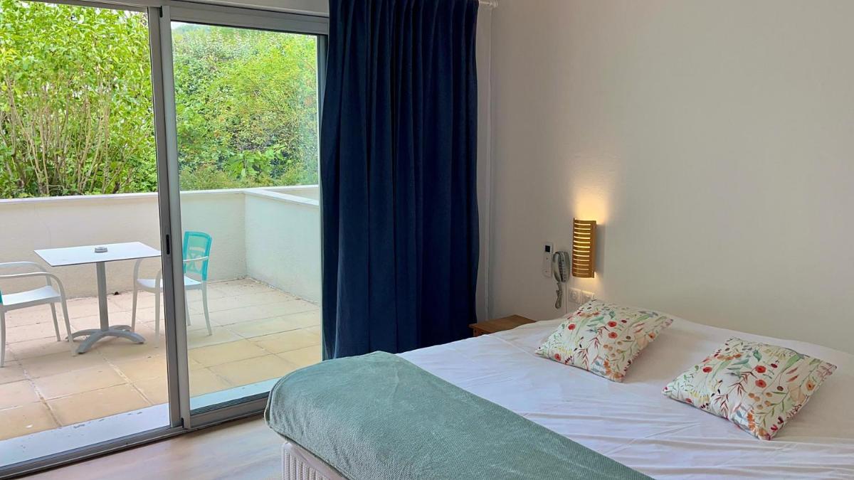 Un ou plusieurs lits dans un hébergement de l'établissement Hôtel La Ségalière Spa Bar