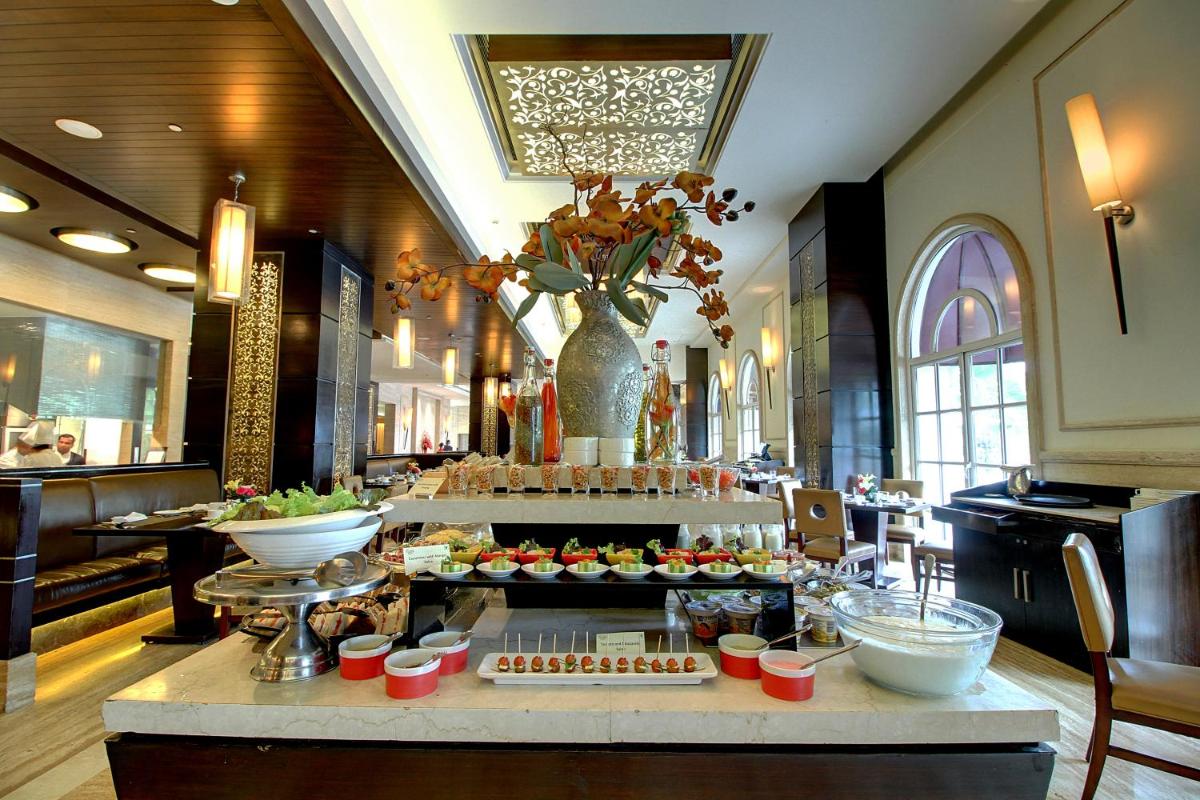 a buffet in a hotel with food on a table at The Pllazio Hotel in Gurgaon
