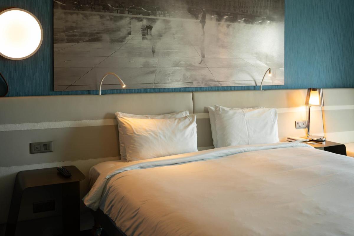 Un ou plusieurs lits dans un hébergement de l'établissement Radisson Blu Hotel Bordeaux