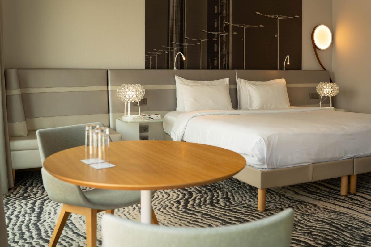 Un ou plusieurs lits dans un hébergement de l'établissement Radisson Blu Hotel Bordeaux
